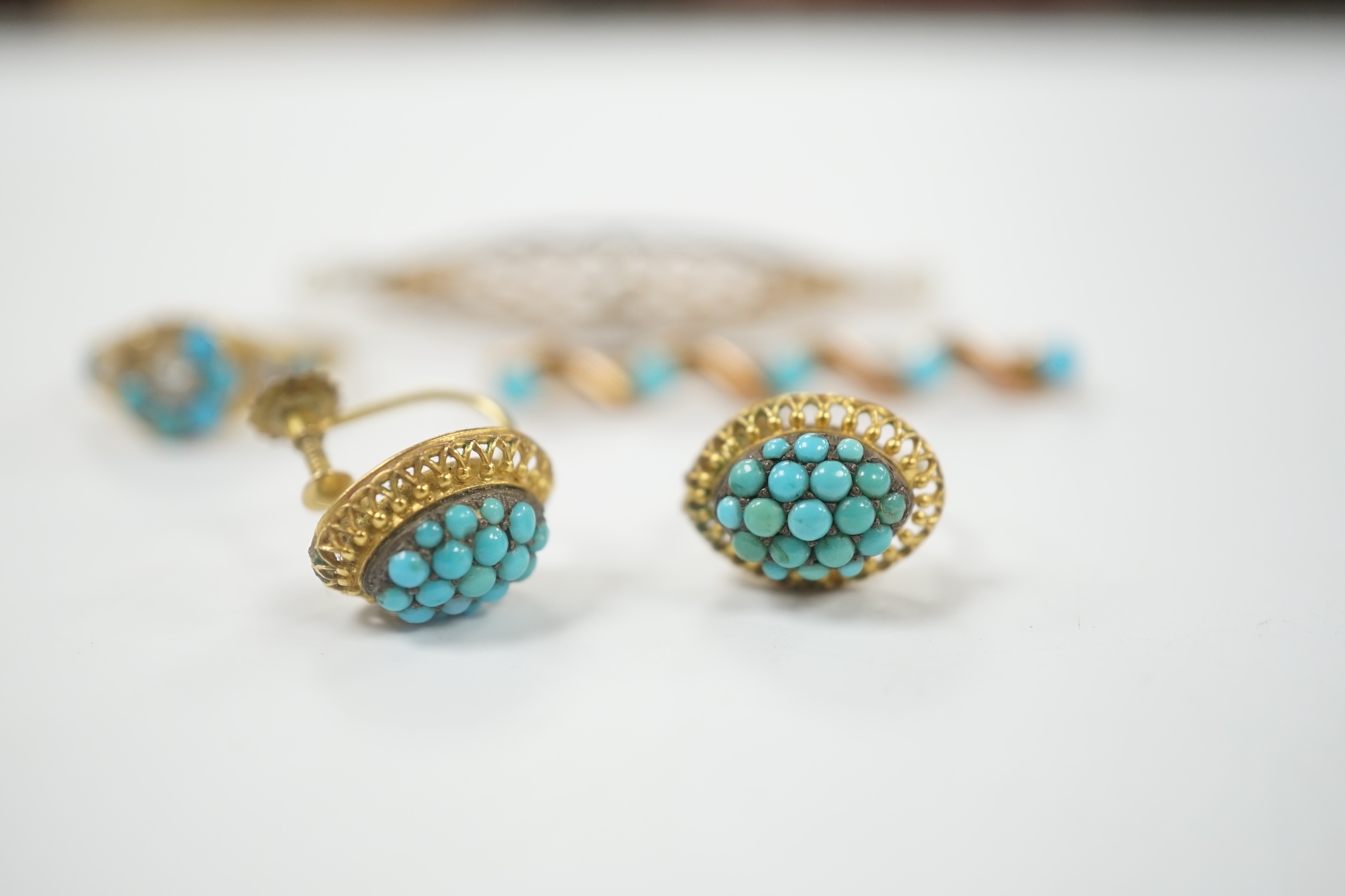 A pair of early 20th century 9ct and turquoise cluster set ear clips, 13mm, together with two yellow metal and gem set brooches and a yellow metal, turquoise and seed pearl cluster set ring (stones missing), gross weight